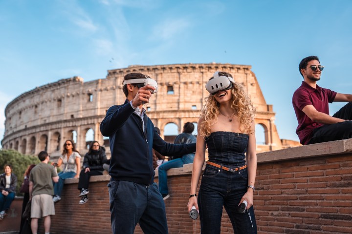 People wearing VR headsets near the Colosseum, enjoying virtual reality experience outdoors.