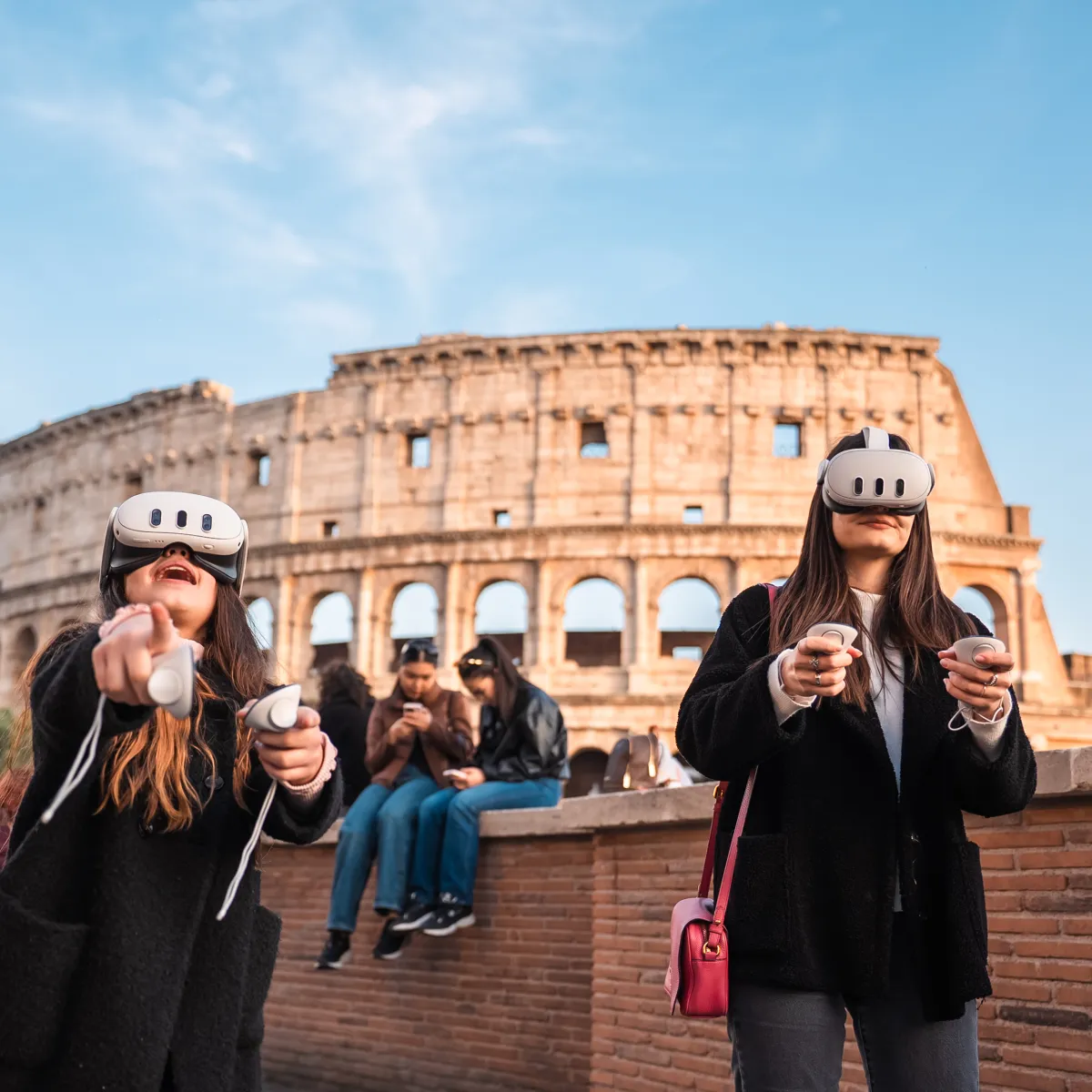 Two people wearing VR headsets near the Colosseum, holding controllers.